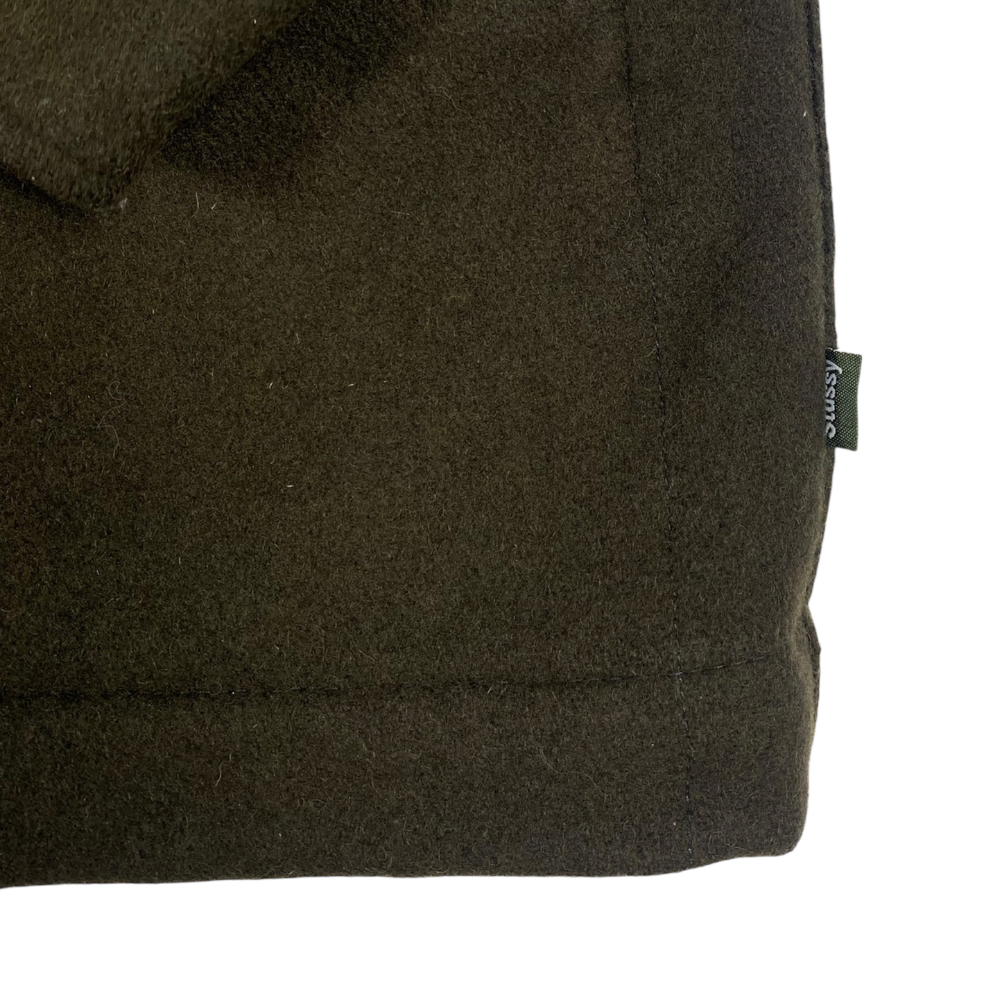 olive green Stüssy jacket features a dark brown corduroy collar