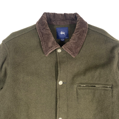 olive green Stüssy jacket features a dark brown corduroy collar